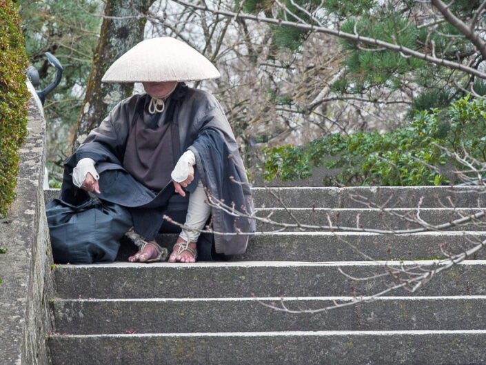 Monk Sitting on Stairs.
