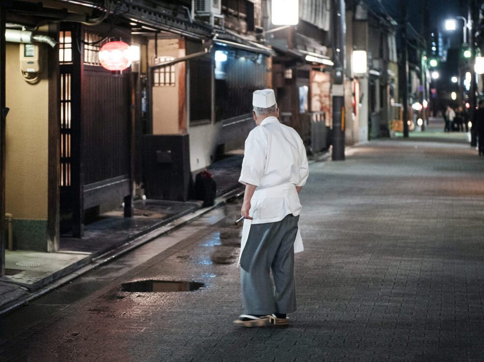 Chef Relaxing in Empty Kyoto Street.